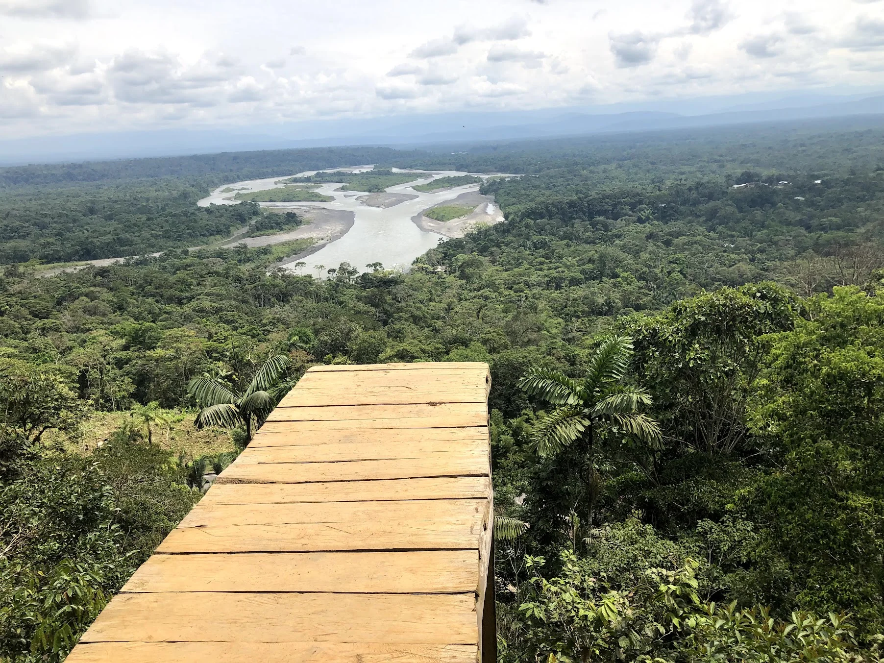 View from a wooden platform over rainforest and river valleys in Ecuador